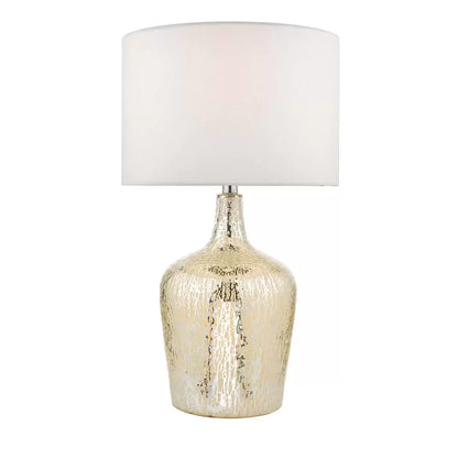 Lolek Silver Glass Dual Light Table Lamp modern reflective bedside and living room lightiA Lolek silver glass table lamp with a glowing, textured mercury finish base and an ivory faux silk drum shade illuminating a cozy bedside table environment.ng lamp