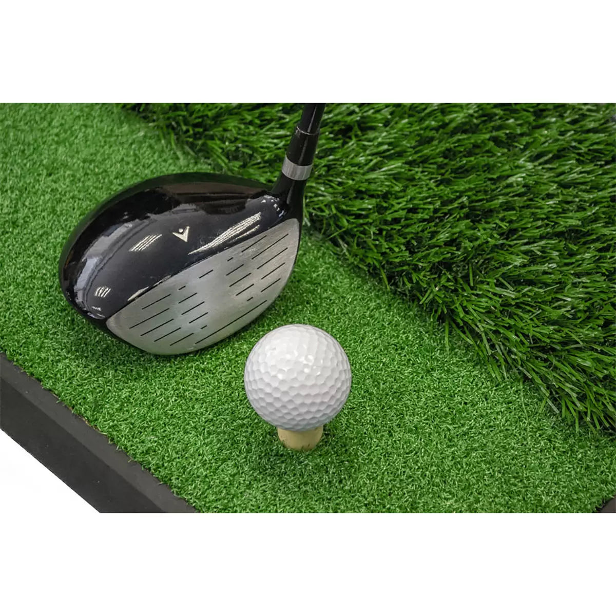 Top-angle studio shot of the green Longridge Dual Golf Practice Mat with a black rubber base, showing the split short fairway turf and long synthetic rough grass next to an upright black rubber tee on a clean white background.