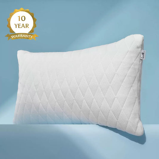 Luff Height Adjustable Prestige Bamboo Pillow with smooth white bamboo cover unzipped to reveal adjustable CloudTec filling on a bed.
