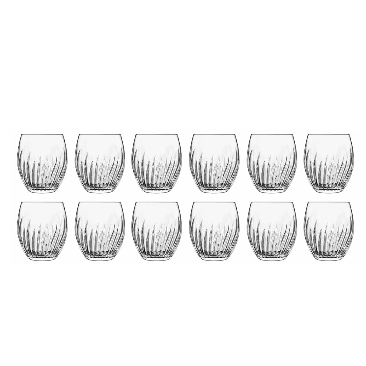 Twelve Luigi Bormioli Mixology cocktail glasses arranged elegantly on a dark bar surface, highlighting their unique decorative pattern and crystal-clear brilliance.