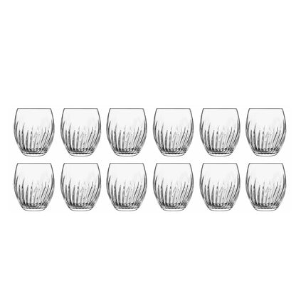 Twelve Luigi Bormioli Mixology cocktail glasses arranged elegantly on a dark bar surface, highlighting their unique decorative pattern and crystal-clear brilliance.