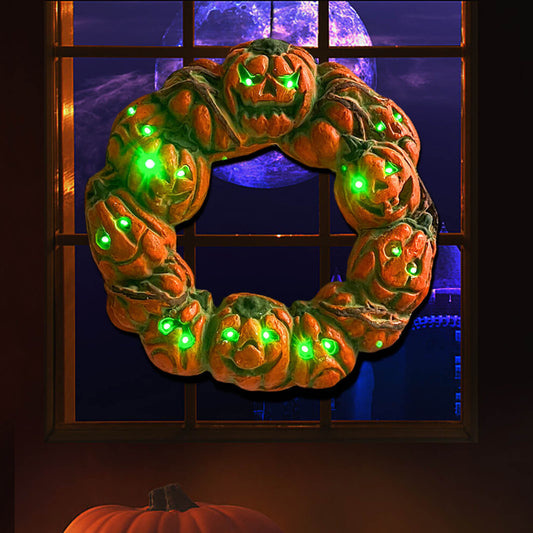 A 50cm multicolor luminous Halloween pumpkin wreath with twisted carvings and glowing eerie details hanging on a dark door.