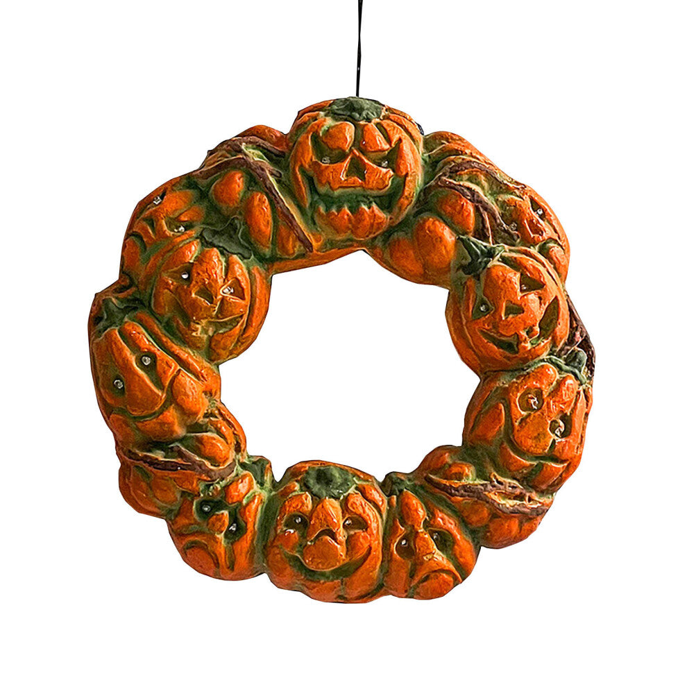 A 50cm multicolor luminous Halloween pumpkin wreath with twisted carvings and glowing eerie details hanging on a dark door.