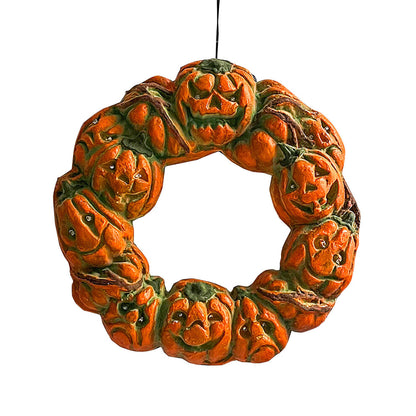 A 50cm multicolor luminous Halloween pumpkin wreath with twisted carvings and glowing eerie details hanging on a dark door.