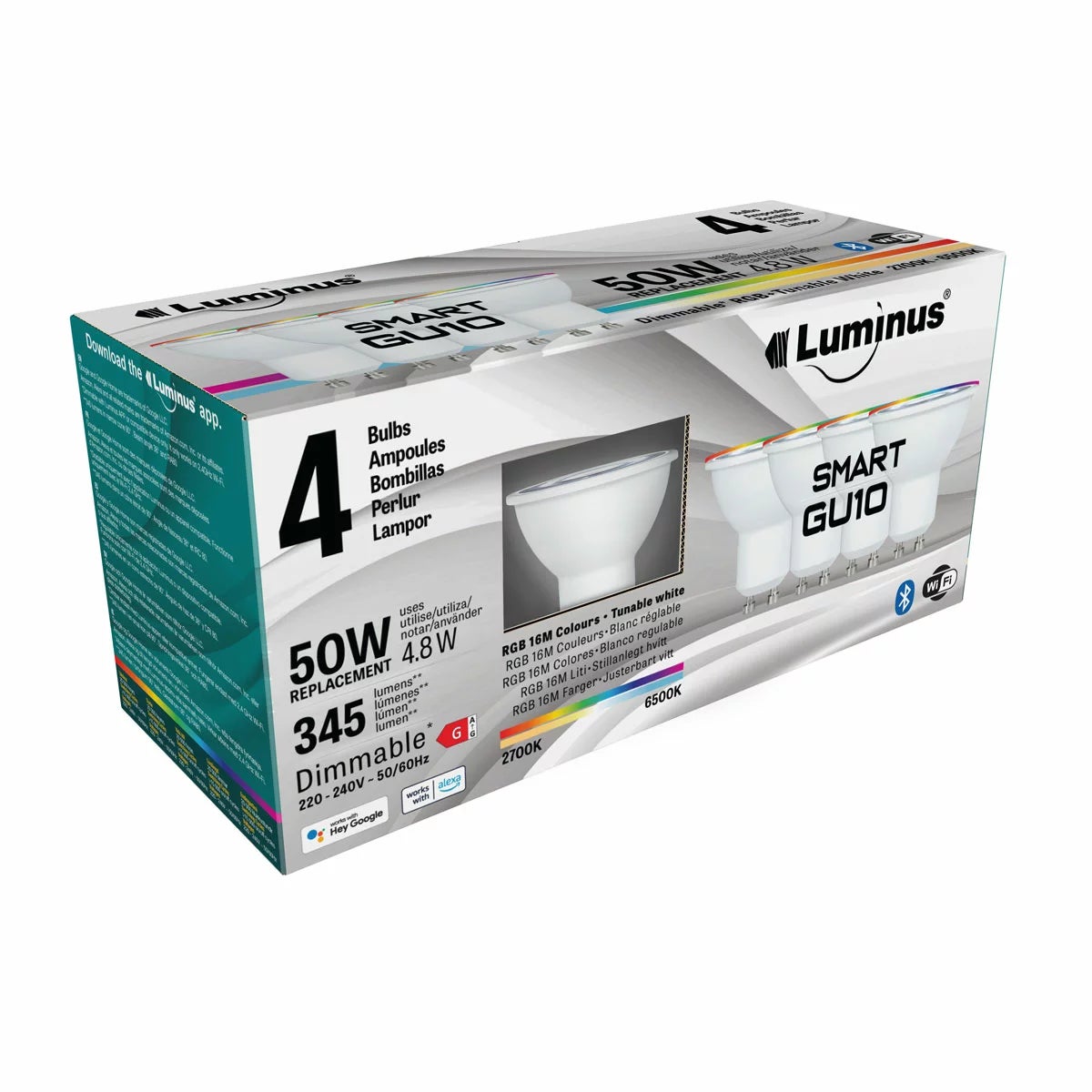 Four white Luminus Smart GU10 LED spotlight bulbs arranged neatly on a dark wooden countertop casting a soft multi-coloured glow.
