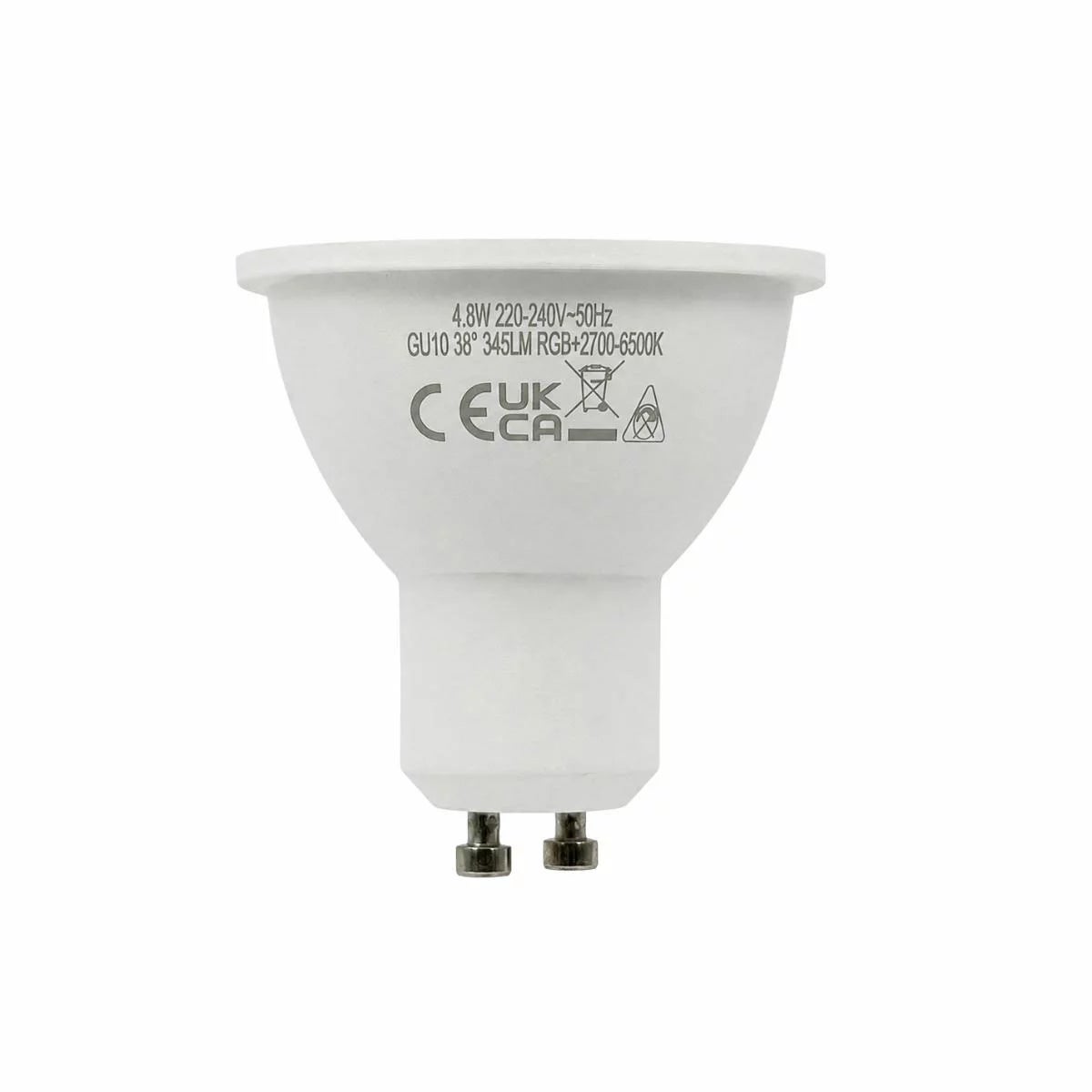 Four white Luminus Smart GU10 LED spotlight bulbs arranged neatly on a dark wooden countertop casting a soft multi-coloured glow.