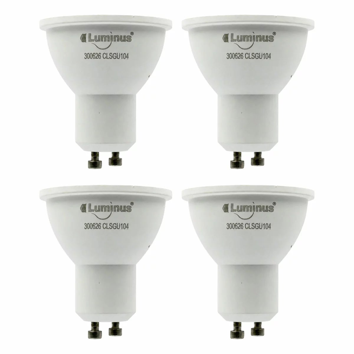 Four white Luminus Smart GU10 LED spotlight bulbs arranged neatly on a dark wooden countertop casting a soft multi-coloured glow.