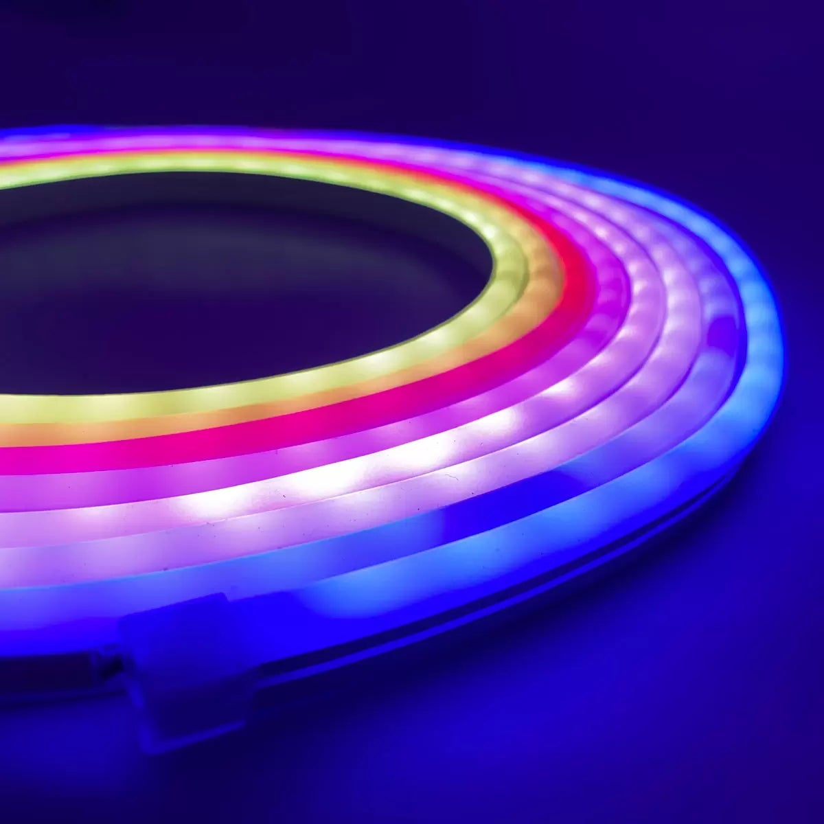 Flexible 5 meter Luminus Smart Wi-Fi Neon Strip Light mounted on a dark bedroom wall displaying colorful segmented RGBIC lighting effects.