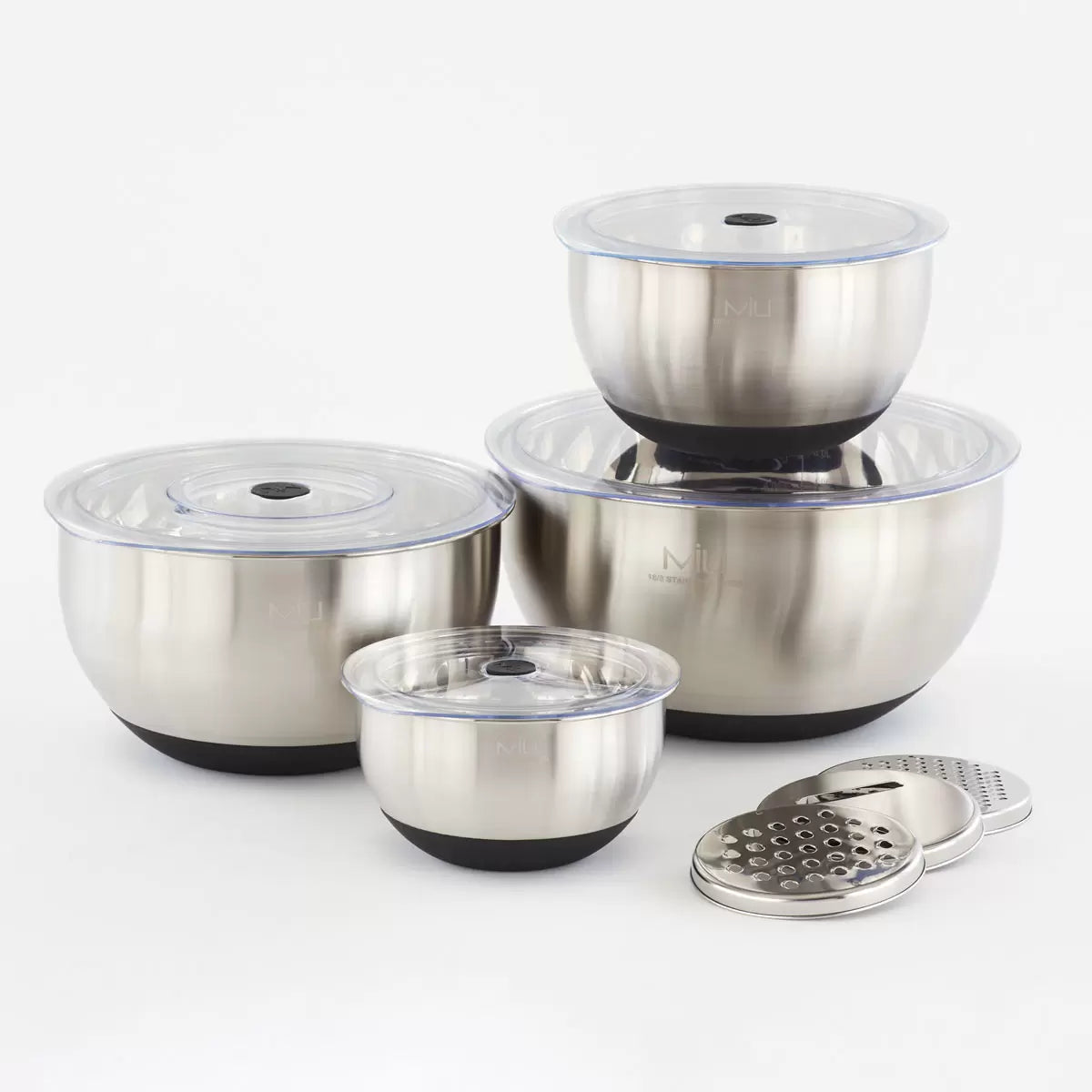 Full 11-piece MIU stainless steel mixing bowl set with graters and lids arranged on a kitchen counter.