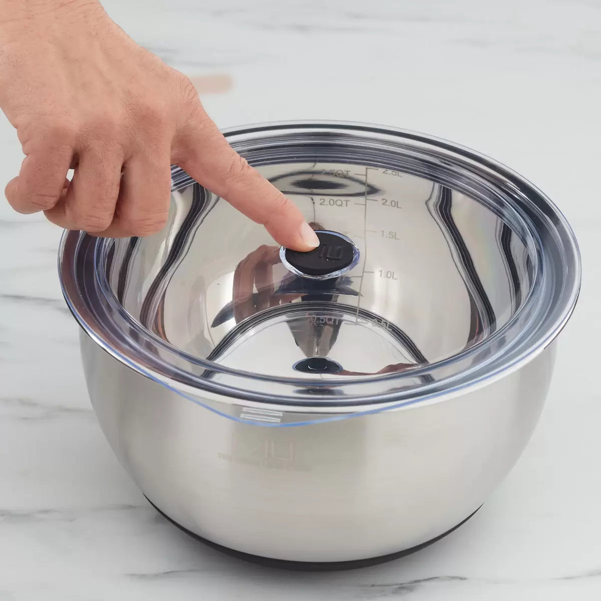 Full 11-piece MIU stainless steel mixing bowl set with graters and lids arranged on a kitchen counter.