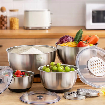 Full 11-piece MIU stainless steel mixing bowl set with graters and lids arranged on a kitchen counter.