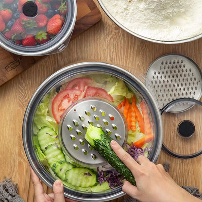 Full 11-piece MIU stainless steel mixing bowl set with graters and lids arranged on a kitchen counter.