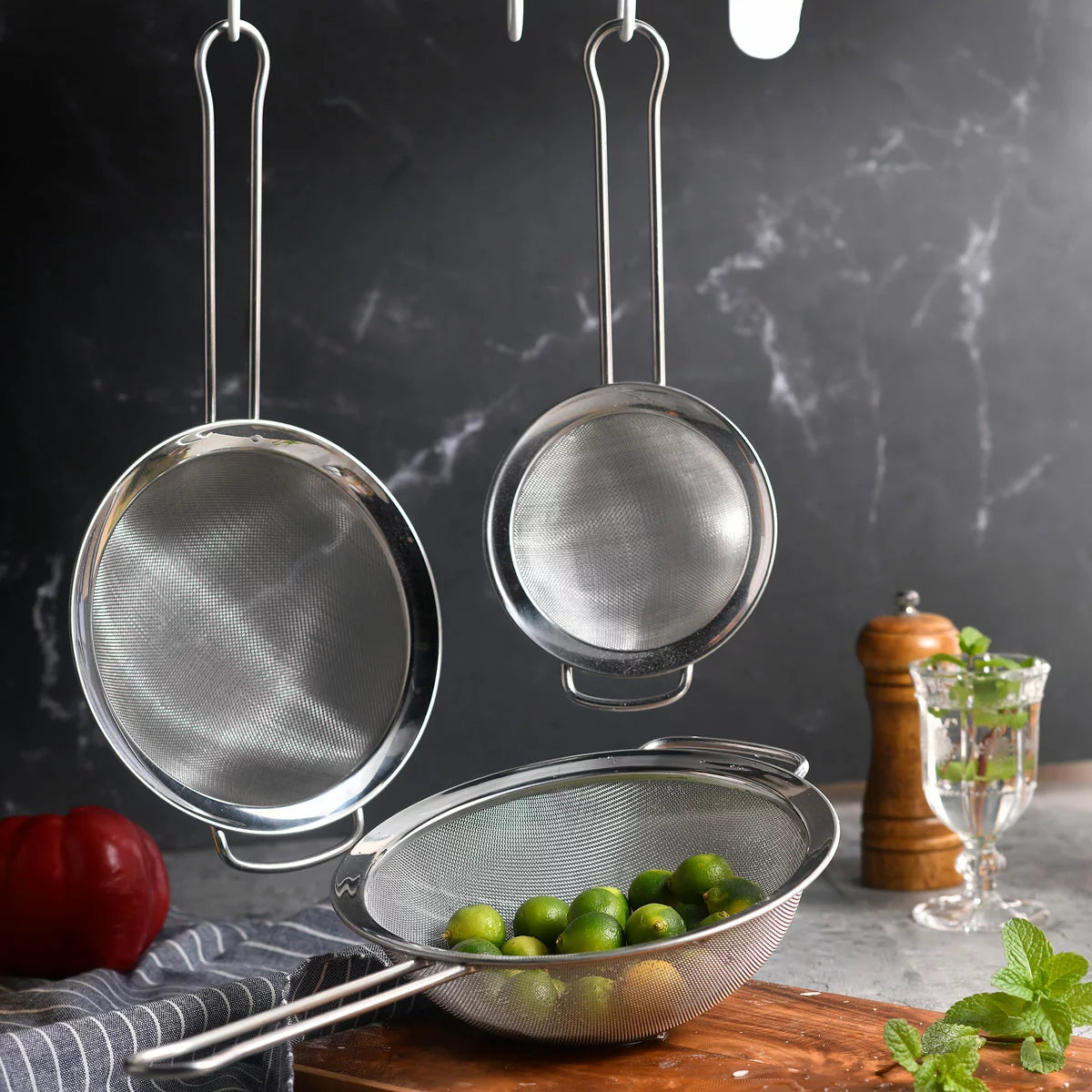 MIU 3-piece stainless steel fine mesh strainer set shown in various sizes on a granite countertop.