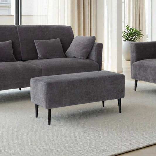 MOONAP Monroe Dark Grey Fabric Footstool with cushioned upholstered top in a contemporary living room setting