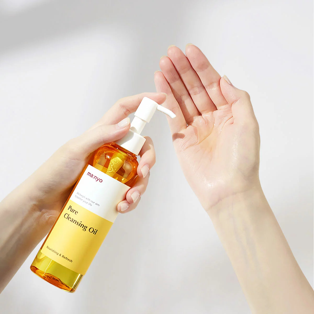Ma:nyo Pure Cleansing Oil set, including two 200ml bottles and one 55ml travel bottle, displayed against a clean, minimalist background.