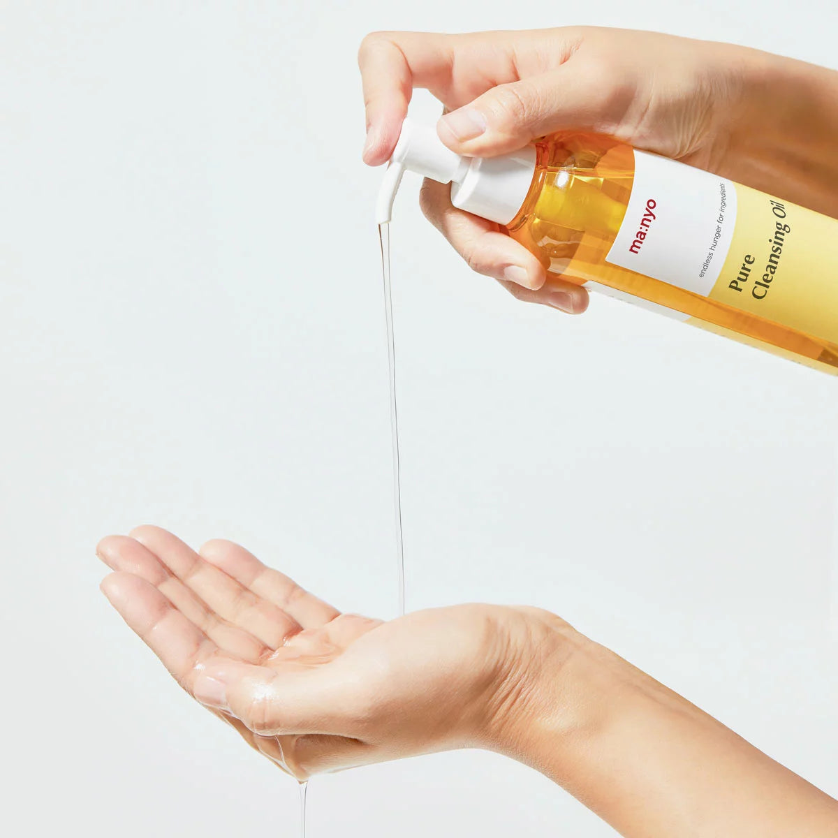 Ma:nyo Pure Cleansing Oil set, including two 200ml bottles and one 55ml travel bottle, displayed against a clean, minimalist background.