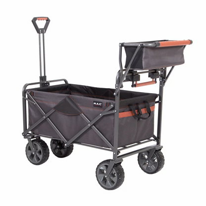A heavy-duty black Mac Sports Deluxe Folding Wagon stands on a grassy field, highlighting its wide all-terrain wheels, integrated front brakes, and extended telescoping handle.