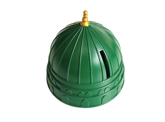 Front view of the hand-painted green dome Masjid Nabawi charity money box with gold minaret details resting on a wooden table.