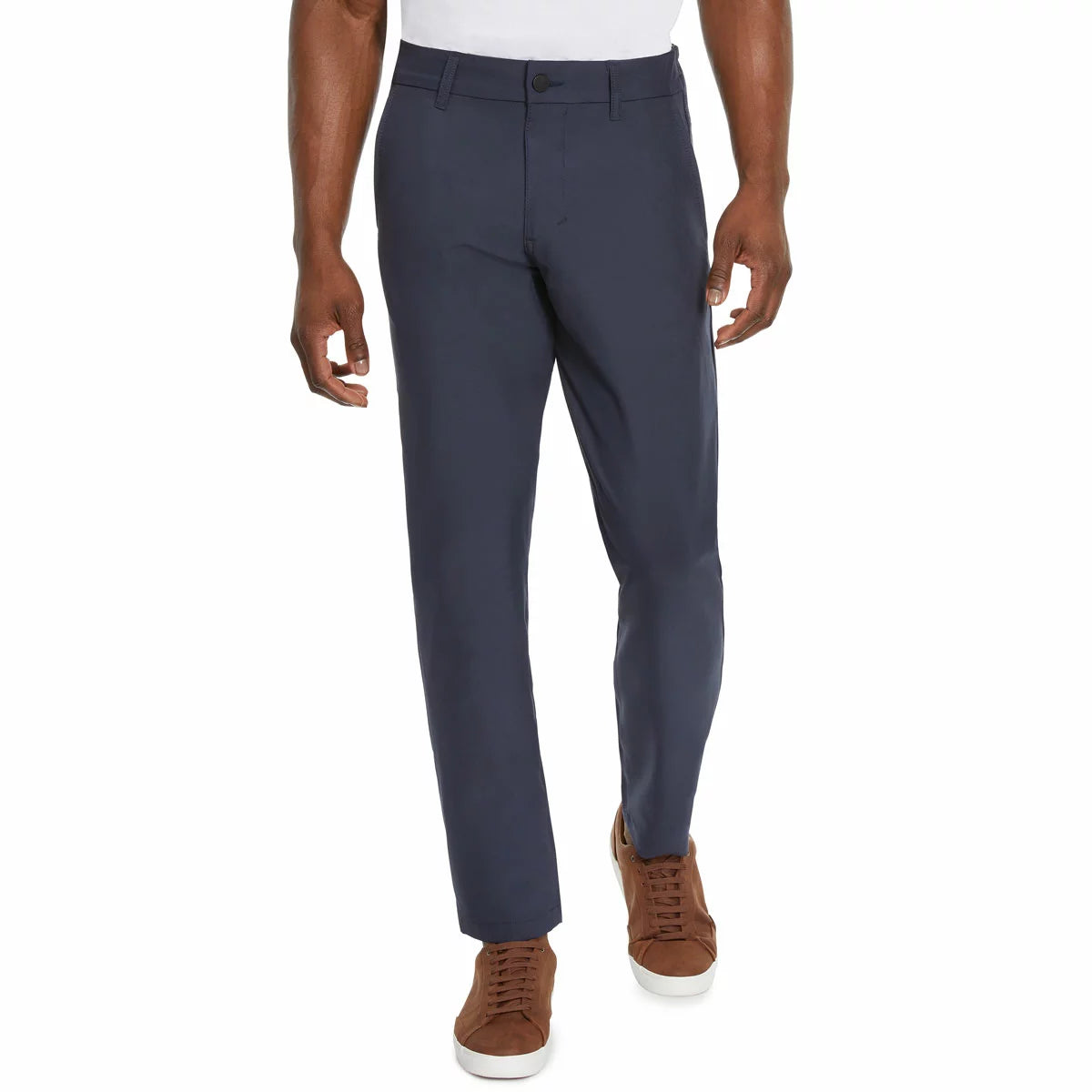 Front view of a model wearing Marc New York men's black commuter pants paired with clean sneakers in a modern studio setting.