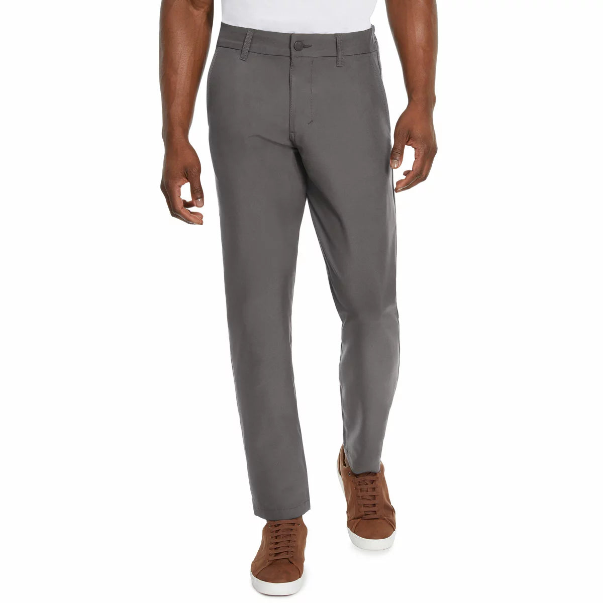 Front view of a model wearing Marc New York men's black commuter pants paired with clean sneakers in a modern studio setting.
