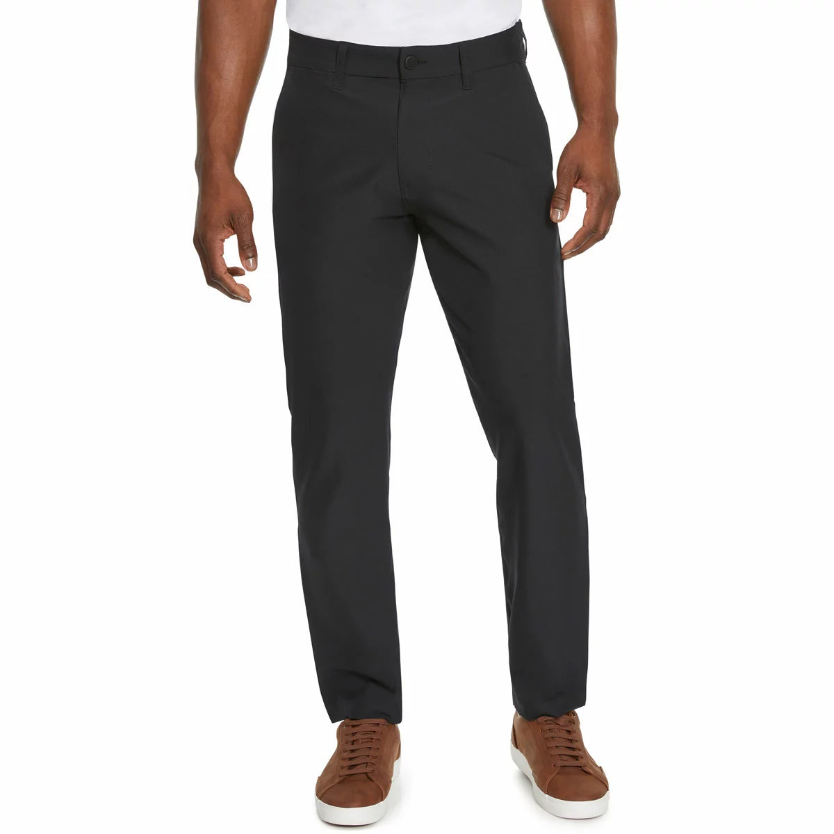 Front view of a model wearing Marc New York men's black commuter pants paired with clean sneakers in a modern studio setting.