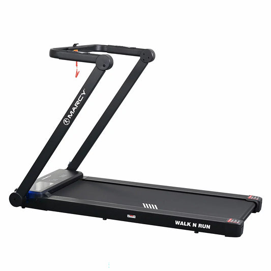 Black Marcy Walk N Run folding walking pad treadmill set up in a modern home office with desk attachment and extended handrails.