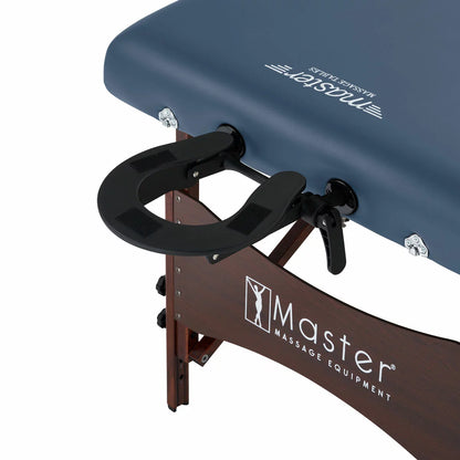 The Master Massage Roma II 76cm portable table in a neutral setting, displayed with its included armrest, bolster, and face cradle accessories.