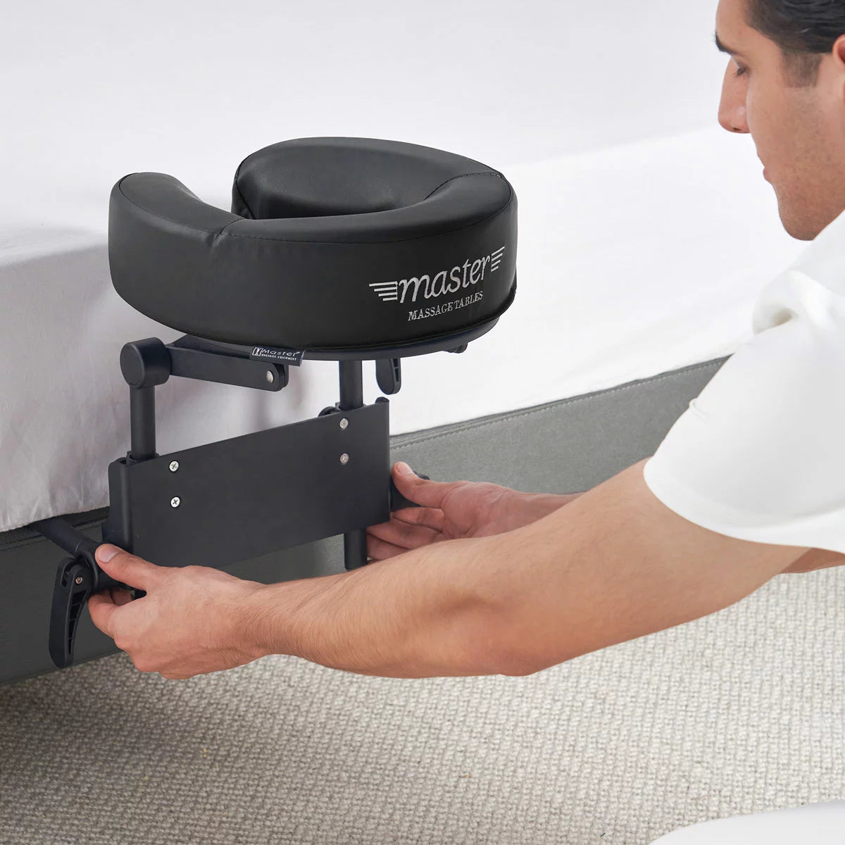 The Master Massage Mattress Top Kit set up on a bed, showing the adjustable face cradle, comfort pillow, and the aluminum frame structure.