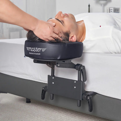The Master Massage Mattress Top Kit set up on a bed, showing the adjustable face cradle, comfort pillow, and the aluminum frame structure.