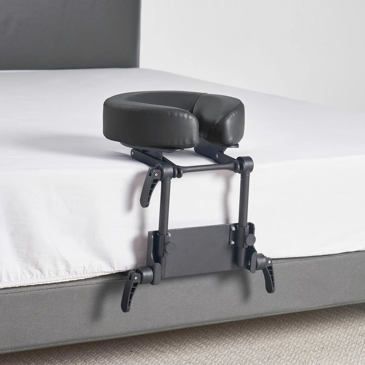 The Master Massage Mattress Top Kit set up on a bed, showing the adjustable face cradle, comfort pillow, and the aluminum frame structure.