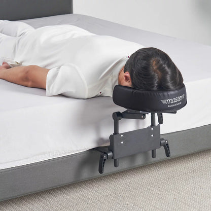 The Master Massage Mattress Top Kit set up on a bed, showing the adjustable face cradle, comfort pillow, and the aluminum frame structure.