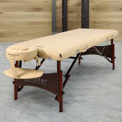 The Master Massage Paradise 71cm portable table in cream, shown in a professional setting with its included accessories, demonstrating its stable wood frame and ergonomic design.