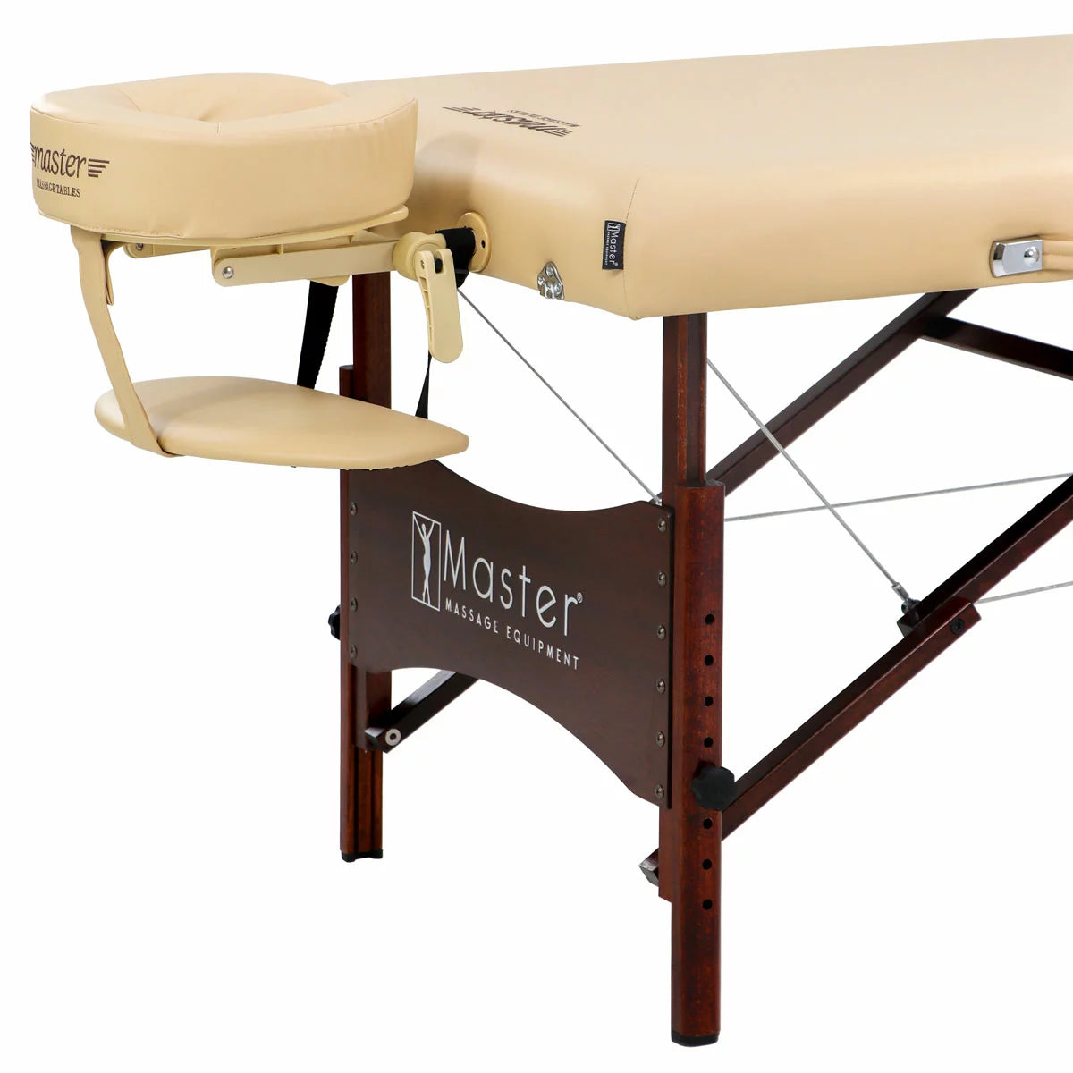 The Master Massage Paradise 71cm portable table in cream, shown in a professional setting with its included accessories, demonstrating its stable wood frame and ergonomic design.