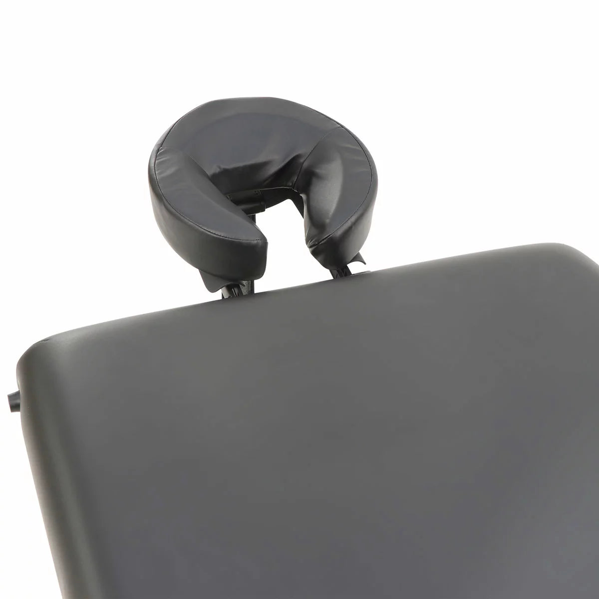 The Master Massage SomeRest table featuring its adjustable liftback in a raised position, displayed in a bright, modern studio with its included face cradle and carrying case nearby.