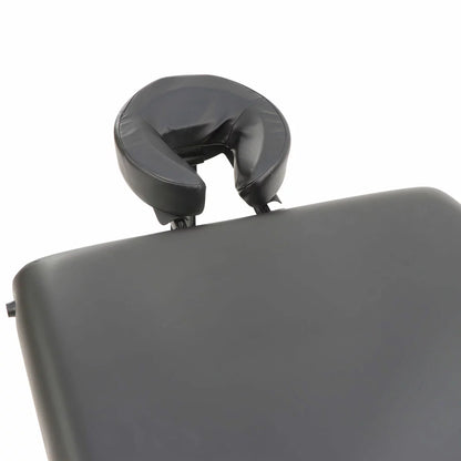 The Master Massage SomeRest table featuring its adjustable liftback in a raised position, displayed in a bright, modern studio with its included face cradle and carrying case nearby.