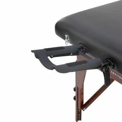 The Master Massage SomeRest table featuring its adjustable liftback in a raised position, displayed in a bright, modern studio with its included face cradle and carrying case nearby.