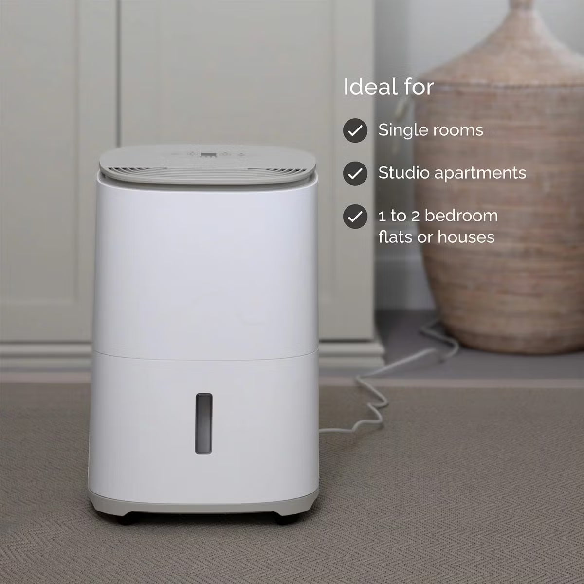Front view of the sleek MeacoDry Arete One 10L Dehumidifier & Air Purifier in a neutral Warm Pebble finish sitting flush against a light grey wall.