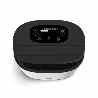 MeacoDry Arete Two 25L Dehumidifier and Air Purifier in charcoal finish with digital LCD display standing on dark hardwood flooring in a spacious living room.