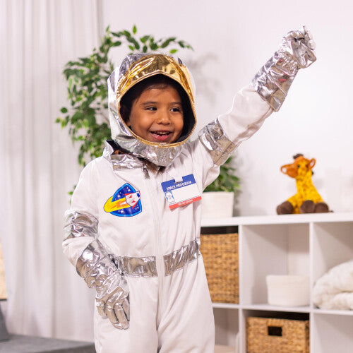 Front view of the white and silver Melissa & Doug kids astronaut costume set including jumpsuit, helmet, gloves, and name badge displayed on a neutral background.