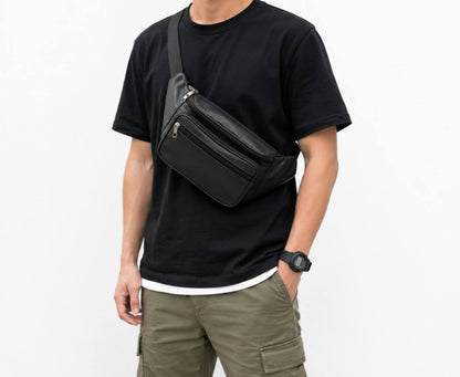 Front angle view of a men's brown premium leather crossbody bag with adjustable shoulder strap resting on a wooden surface.