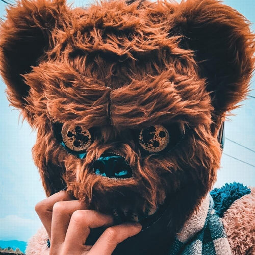 Front view of a dark brown plastic scary bear costume mask for men displayed against a neutral background for Halloween cosplay.