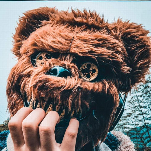 Front view of a dark brown plastic scary bear costume mask for men displayed against a neutral background for Halloween cosplay.