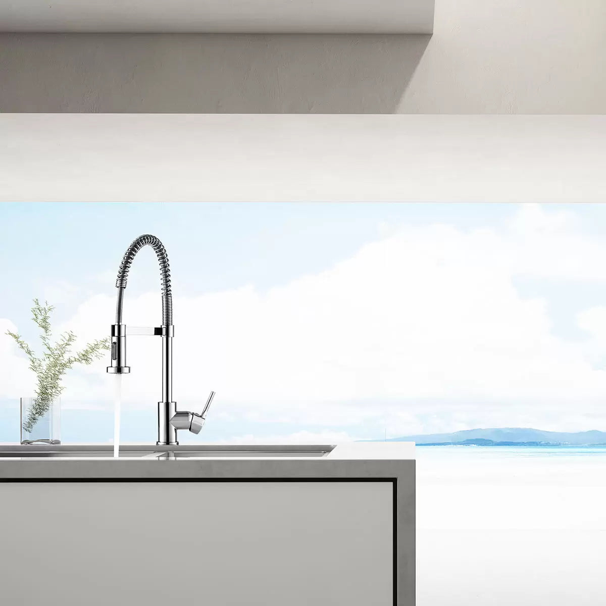 A close-up view of the chrome Methven Slinky Pull Out Kitchen Rinser Tap showing its distinctive spring-coiled neck and dual-function nozzle over a modern undermount stainless steel sink.