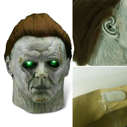 Front angle view of a realistic white Michael Myers horror latex mask featuring dark synthetic hair and aged detailing on a dark background.