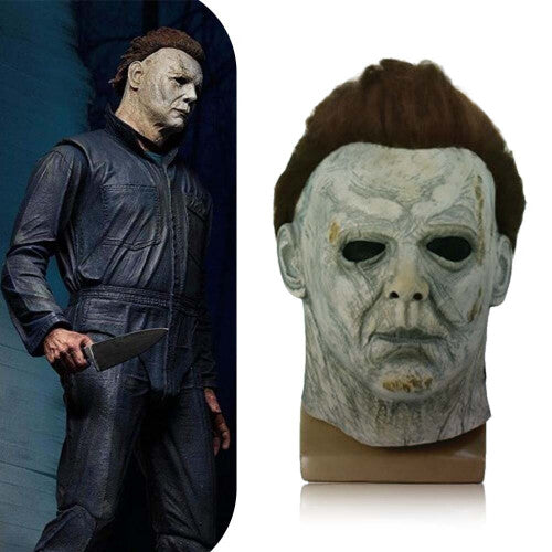 Front angle view of a realistic white Michael Myers horror latex mask featuring dark synthetic hair and aged detailing on a dark background.
