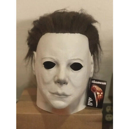 Close-up of the adult Michael Myers deluxe latex horror mask featuring detailed matte skin texture and realistic face sculpt against a dark background.