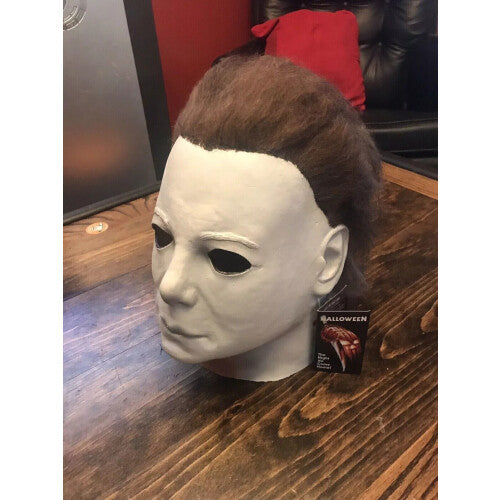 Close-up of the adult Michael Myers deluxe latex horror mask featuring detailed matte skin texture and realistic face sculpt against a dark background.