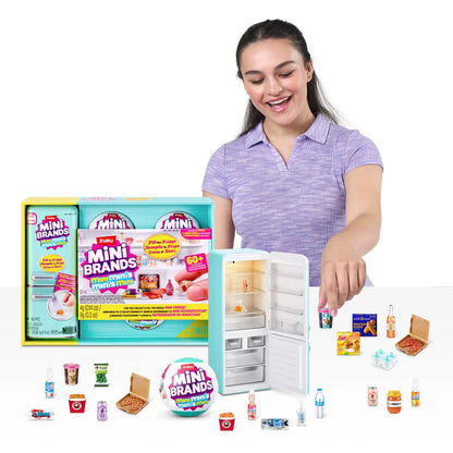 Front angle view of the Mini Brands Fill the Fridge playset showing an open mini refrigerator filled with miniature grocery items alongside five surprise capsules on a white surface.