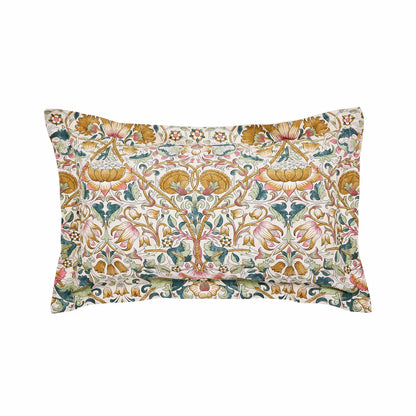 A wide angled shot of the Morris and Co Lodden Primrose duvet cover set outspread on a master bed highlighting the detailed interlocking yellow and beige floral patterns.