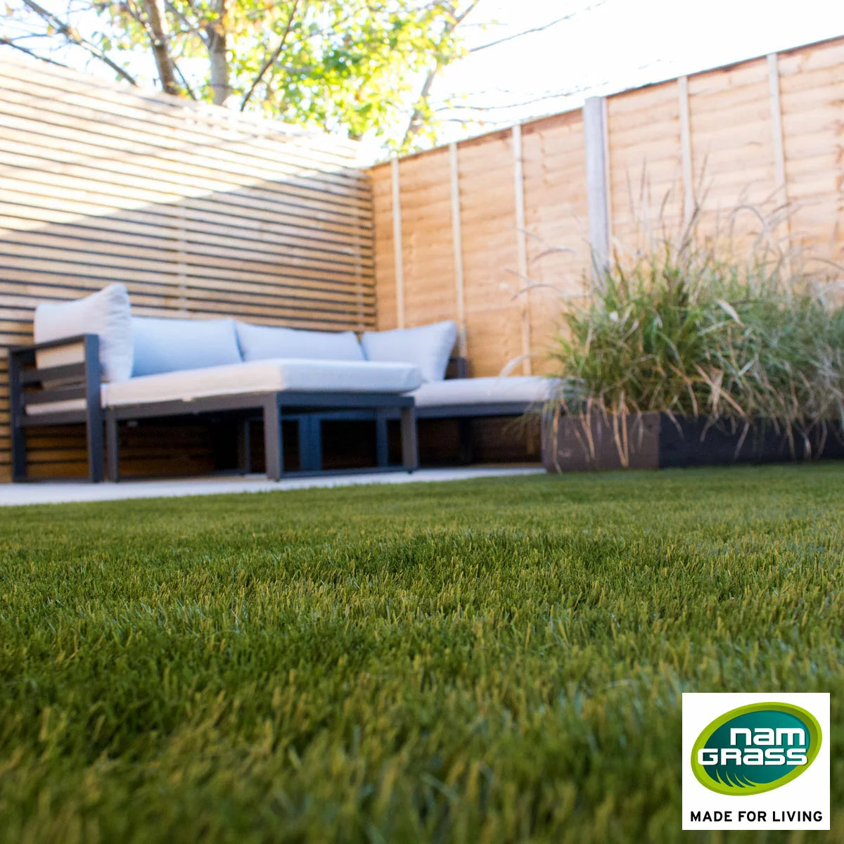 Close-up of the dense, realistic green pile of Namgrass Pragma 40mm artificial grass roll for domestic gardens.